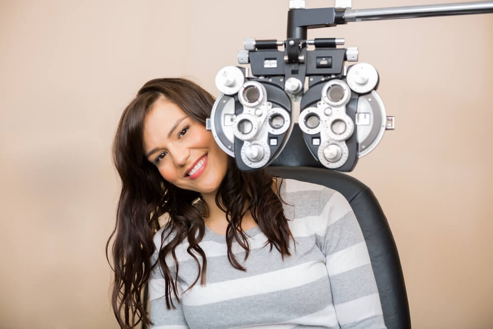 Smiling woman getting an eye exam