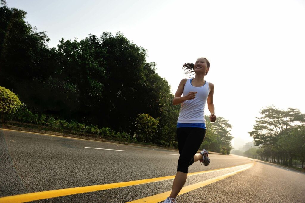 Woman running on a road